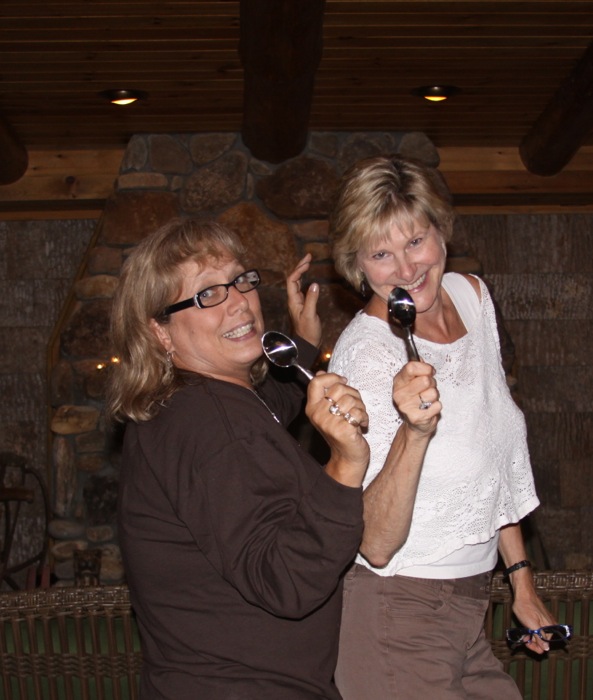 Ann and Kathy with spoons on Camp Chimney porch photo by Kathy Miller