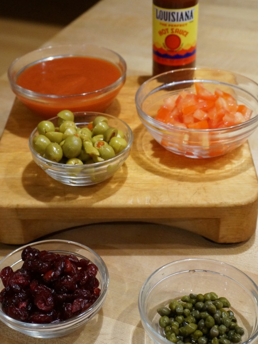 Louisiana Picadillo ingredients tomato sauce, green olives chopped tomatoes, dried cranberries and capers...and your favorite hot sauce photo by Kathy Miller