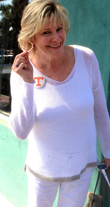 Kathy and her signature orange and white striped earrings and big T button for Tennessee photo by Kathy Miller