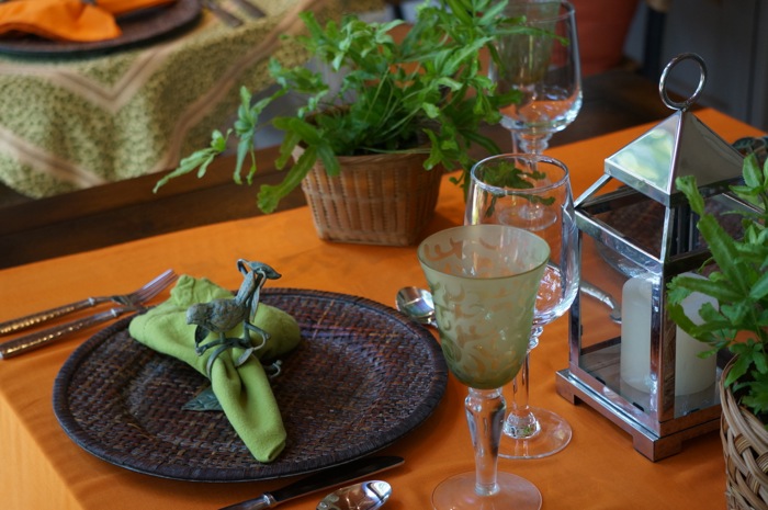 Green crystal goblet on orange shawl photo by Kathy Miller