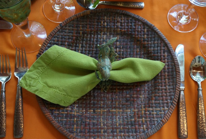 Green napkin on orange tablecloth photo by Kathy Miller