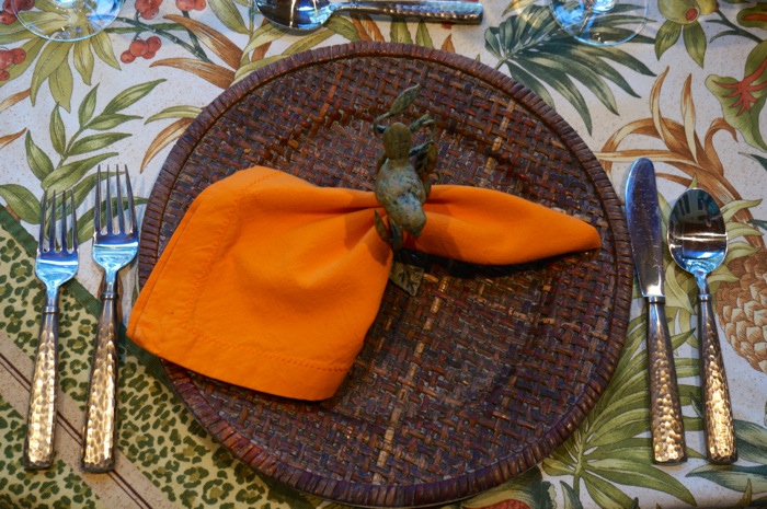 Orange napkin on Green and orange floral tablecloth