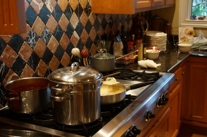 Stove top with pots, pans and sauces photo by Kathy Miller