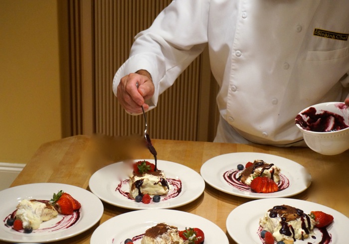 Francesco's drizzles chocolate on his Tiramisu photo by Kathy Miller