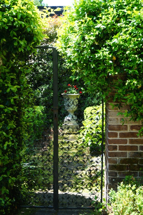 The urn in the rear garden with iron gates photo by Kathy Miller