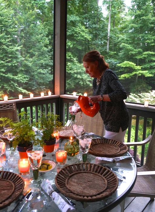 Susan pouring water at table photo by Kathy Miller