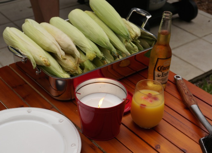 Corn on the Cob ready for the grill along with Corona Beer and a mimosa with fruit photo by Kathy Miller