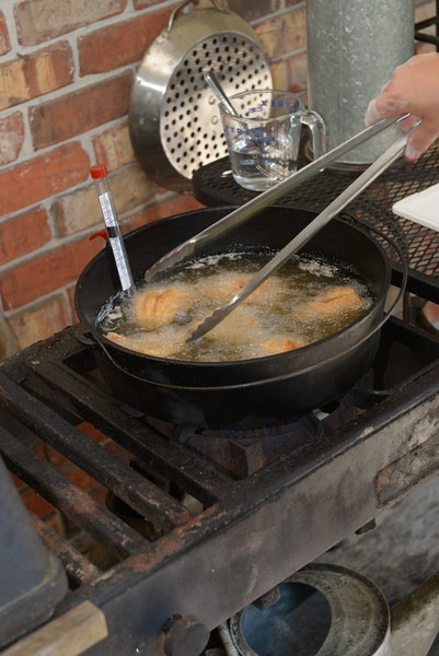 Catfish frying in cast iron skillet photo by Frank Cobb Photography
