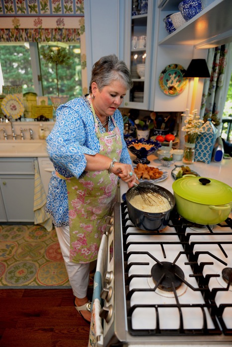 Joy stirring the Cheese Grits photo by Frank Cobb Photography