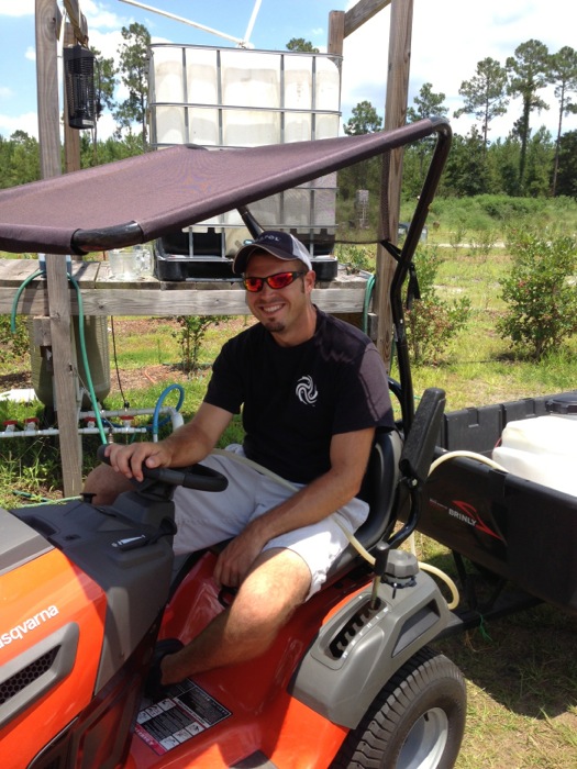 Josh Bunk after fertilizing blueberry bushes photo by Kathy Miller