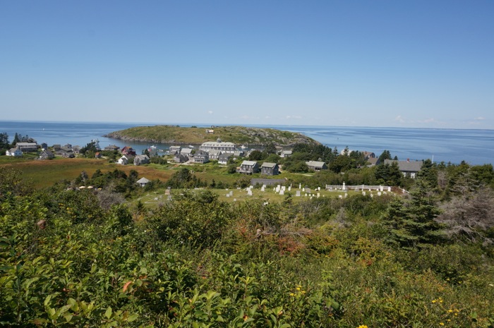 View of Monhegan Village, Monhegan Harbor, the cemetery, and Manana Island from Monhegan Lighthouse photo by Kathy Miller