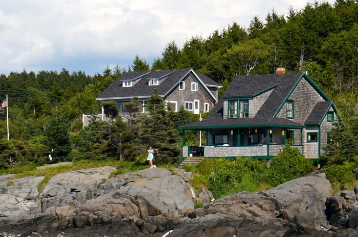 Woman waving from the rocks Monhegan Island photo by Kathy Miller