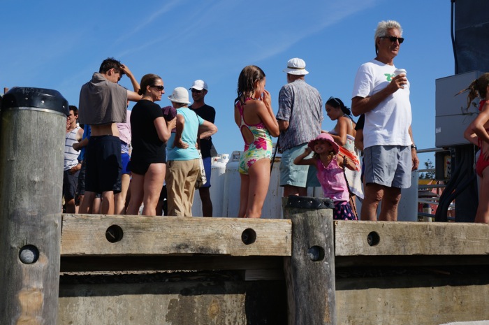 The pier on Monhegan Island with waiting loved ones photo by Kathy Miller