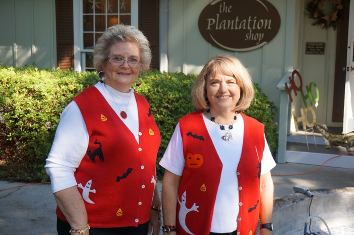 Martha and Pat in their red sweater vests with Halloween cutouts photo by Kathy Miller