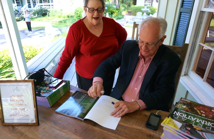 Loran Smith signing a book for Ellen photo by Kathy Miller