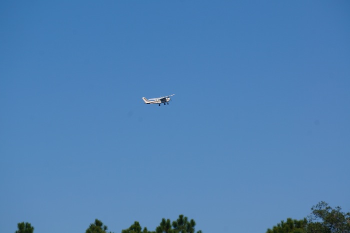 a small aircraft takesoff right after the trikes photo by Kathy Miller