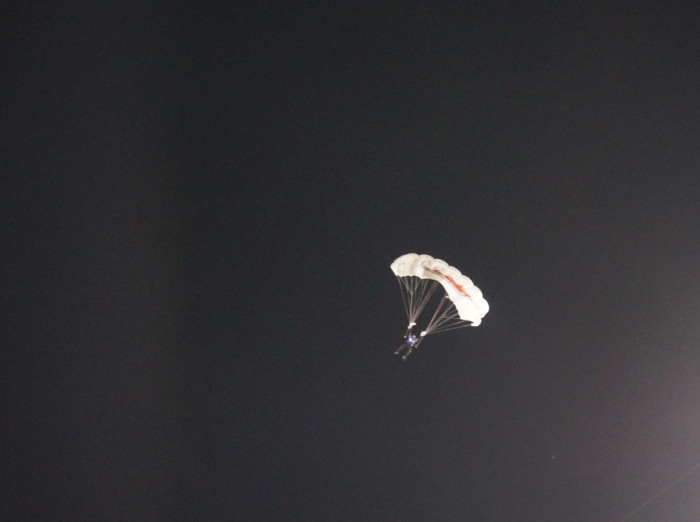 Parachutist at Duke/UNC game photo by Kathy Miller