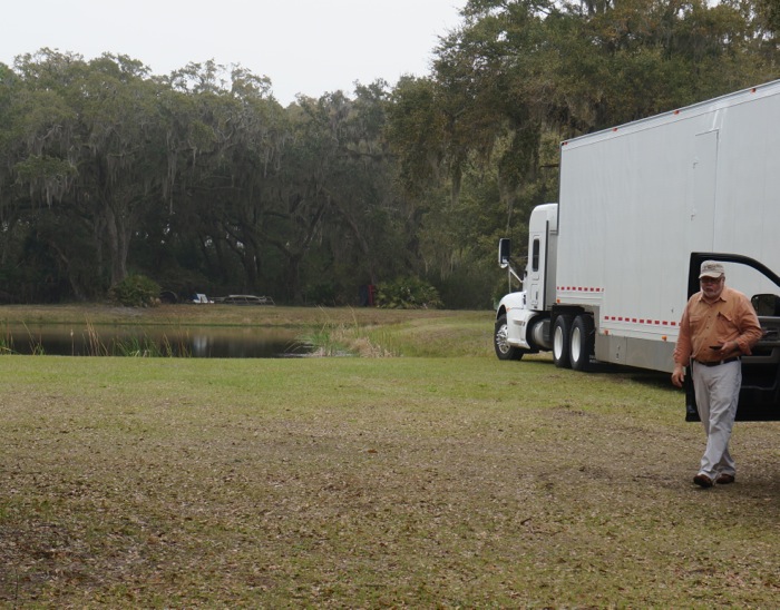 Picnic In The Grass spot with tractor trailer bringing cars to Amelia Island Concours d'Elegance photo by Kathy Miller