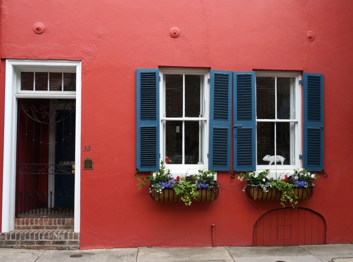 Red House with window boxes and pig in window photo by Kathy Miller