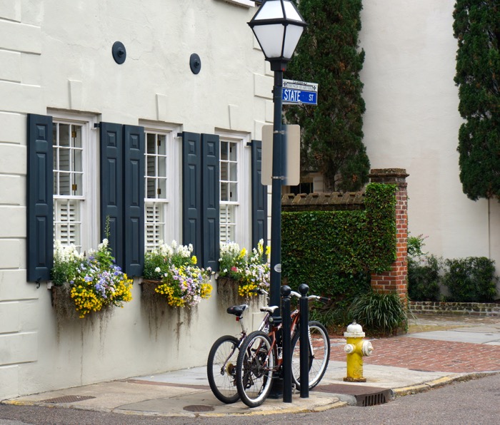 Window Boxes with pop of yellow and bikes photo by Kathy Miller