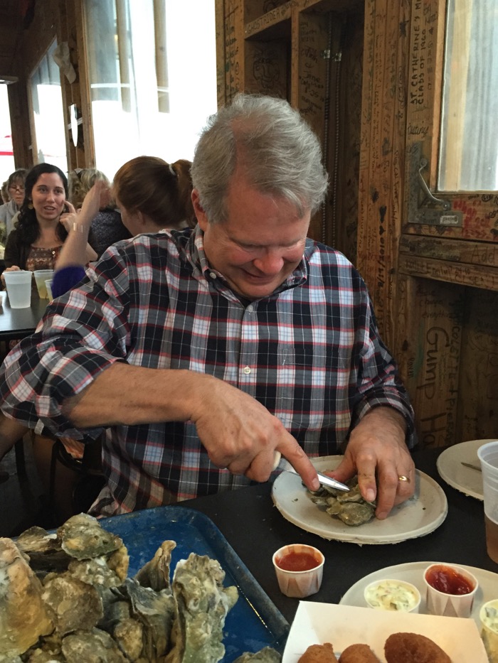 Phil shucking oysters photo by Kathy Miller