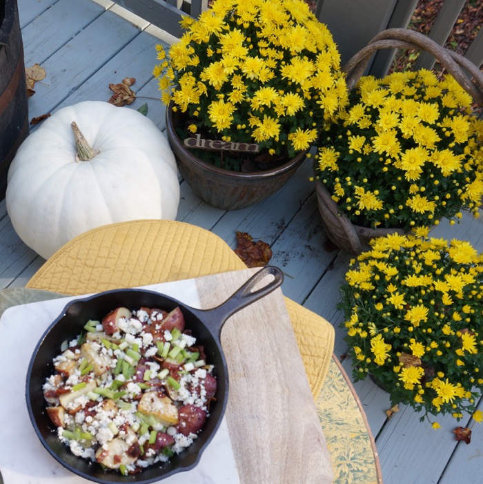 Fall mums, white pumpkin, and Red Potato Salad with Crispy Bacon Dressing In a Skillet