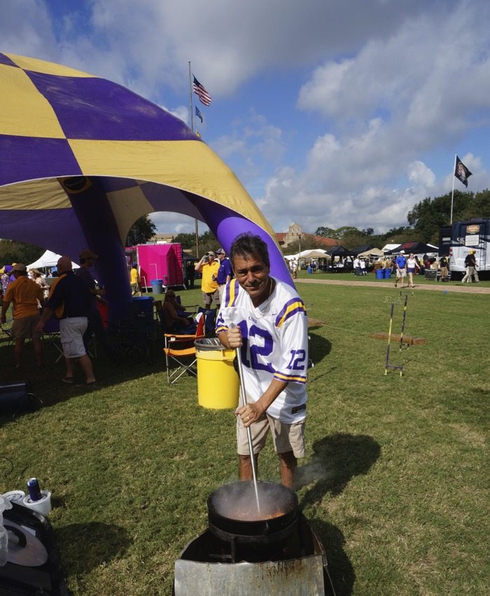 LSU fan stirs a big pot of picadillo photo by Kathy Miller