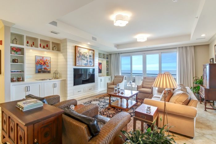 Spyglass Living with center TV and Dennis Campay painting over TV