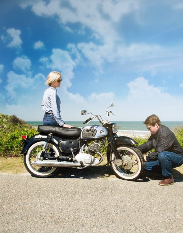 Mike checks tires on 1965 Honda Dream motorcycle while Gloria looks on photo by Susan Scarborough