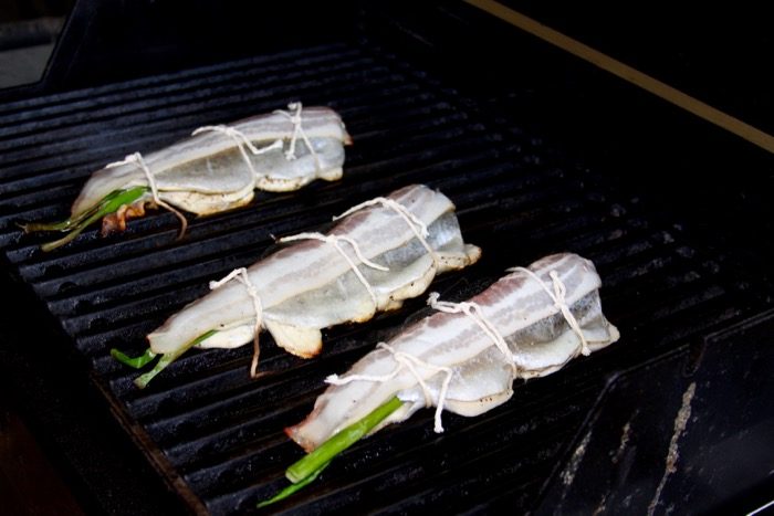 Bacon wrapped mountain trout on the grill photo by Kathy Miller