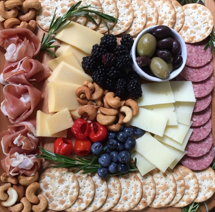 Cheese board close up with proscuitto florets photo by Kathy Miller