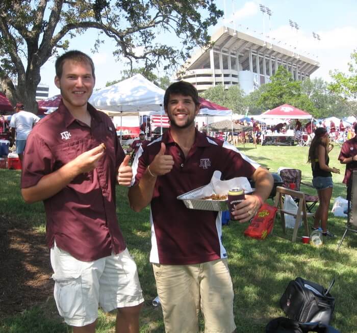 Tanner and Aggie fans serve Gator tail photo by Kathy Miller