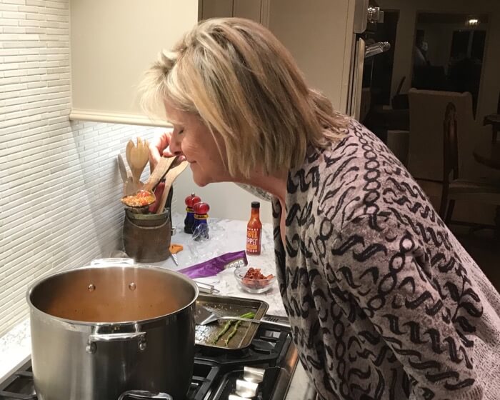 Kathy tasting Minorcan Clam Chowder photo by Kathy Miller