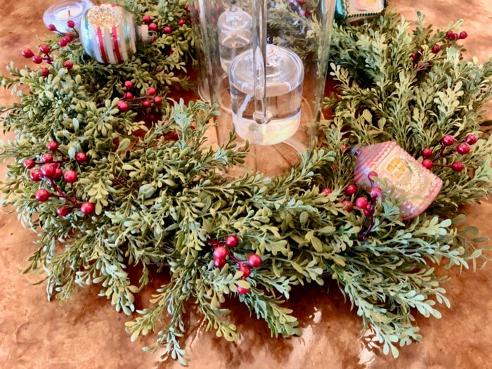 Dining tables cape, a boxwood wreath with antique ornaments photo by Kathy Miller