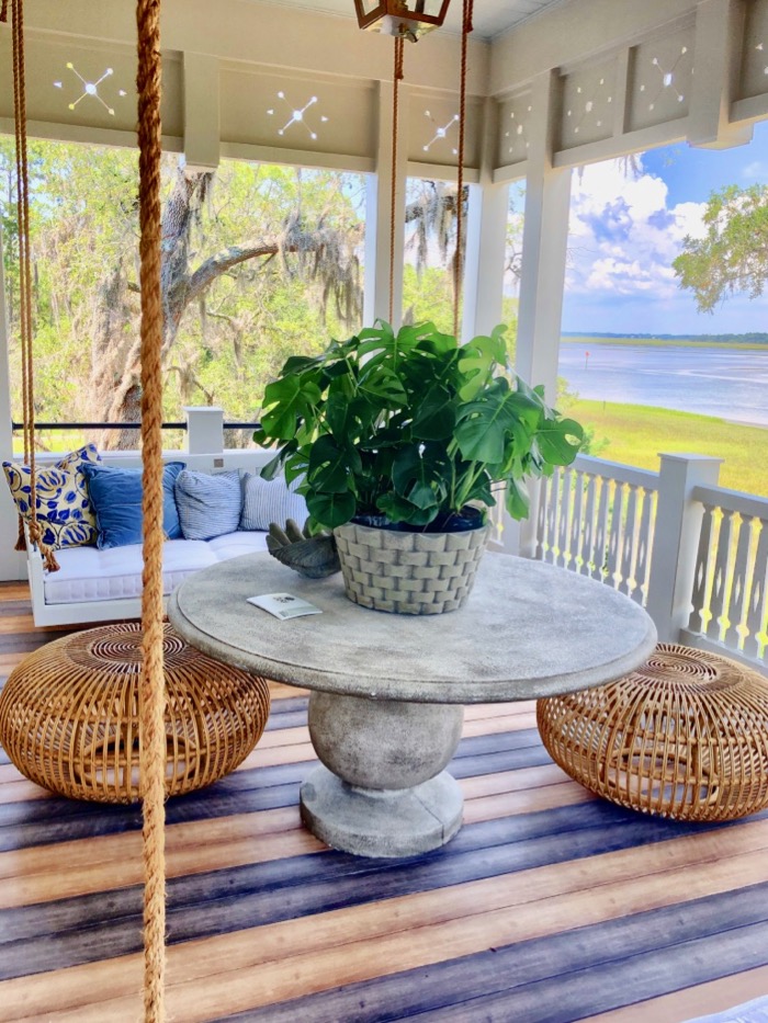 Upstairs porch with wicker pouf ottomans Southern Living 2019 Idea House