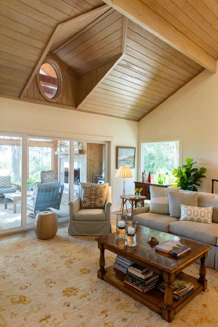 Living area with view through screened porch to the marsh photo by Lynn Tenille