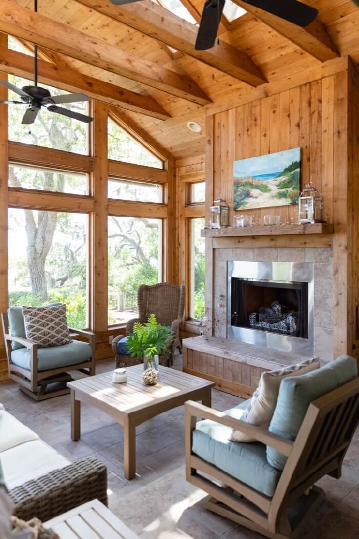 Screened porch with fireplace and Kathy Miller original's beach painting photo by Lynn Tenille