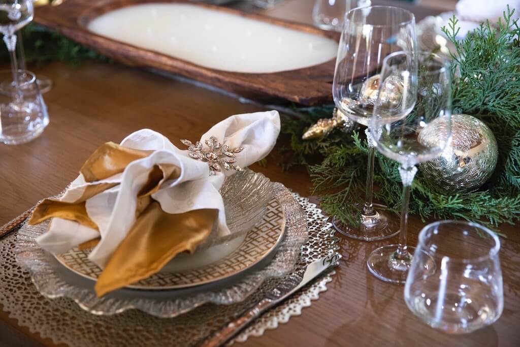 tablescape with gold, silver, cyrstal and greenery photo by Clay Greenhaw