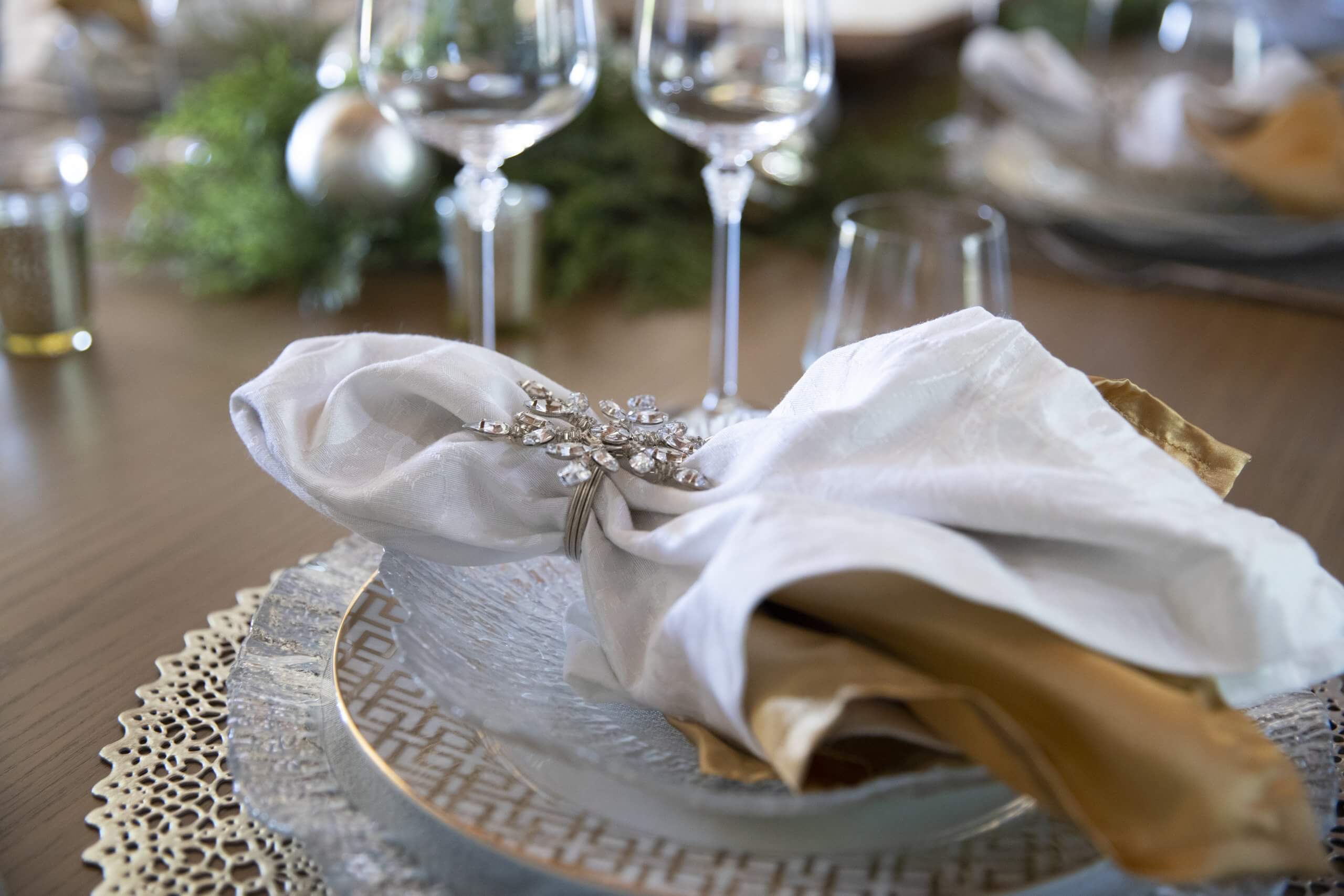 Christmas table setting using gold, silver, crystal and greenery photo by Clay Greenhaw