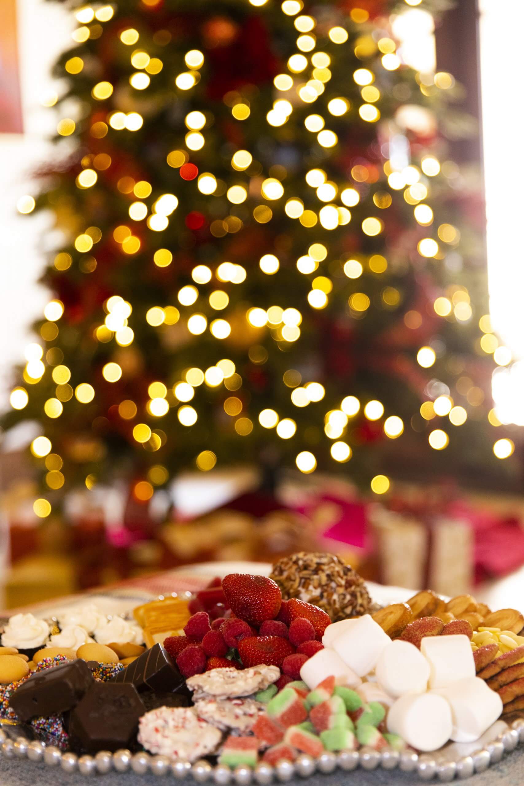 Dessert charcuterie board with red, green gold Christmas tree photo by Clay Greenhaw