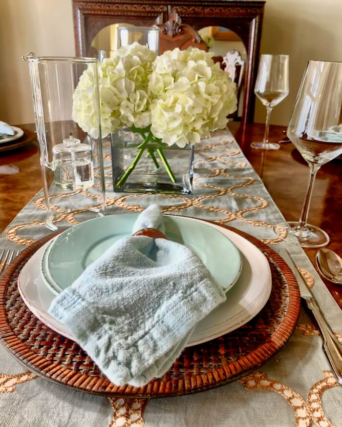 Table setting with aqua and gold runner setting the tone with shell napkin rings photo by Kathy Miller