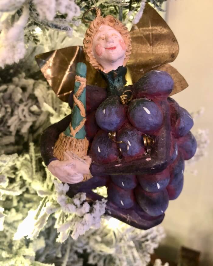 Grape Fairy holding a bottle of wine photo by Kathy Miller