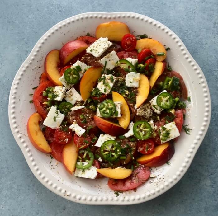 Summer tomato salad with peaches and jalapenos photo by Kathy Miller