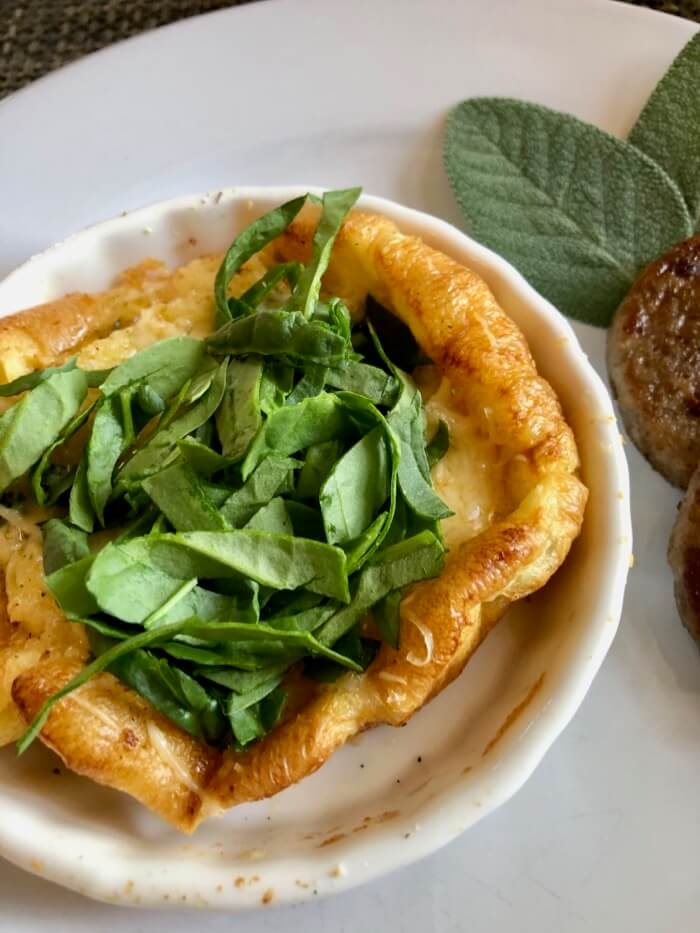 Dutch Baby in flan pan with thyme and spinach photo by Kathy Miller